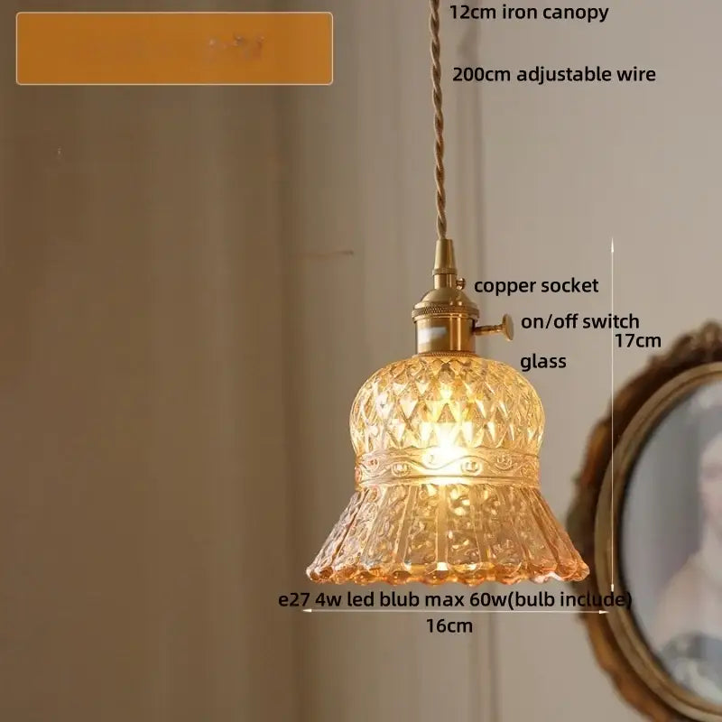 A decorbites amber glass led pendant light with warm amber hue and brass-toned fittings in modern nordic style