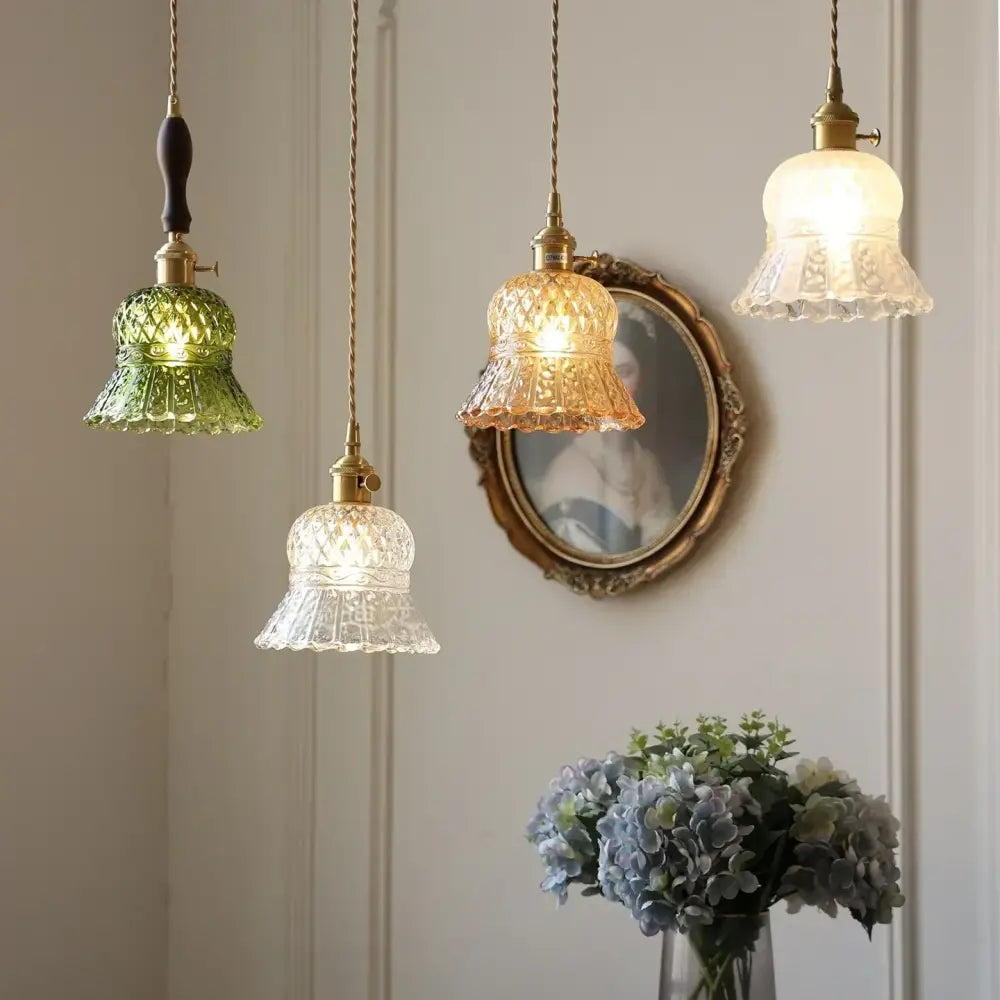 Three vintage-style pendant lights with green amber and clear textured glass shades suspended by brass chains decorbites amber glass led