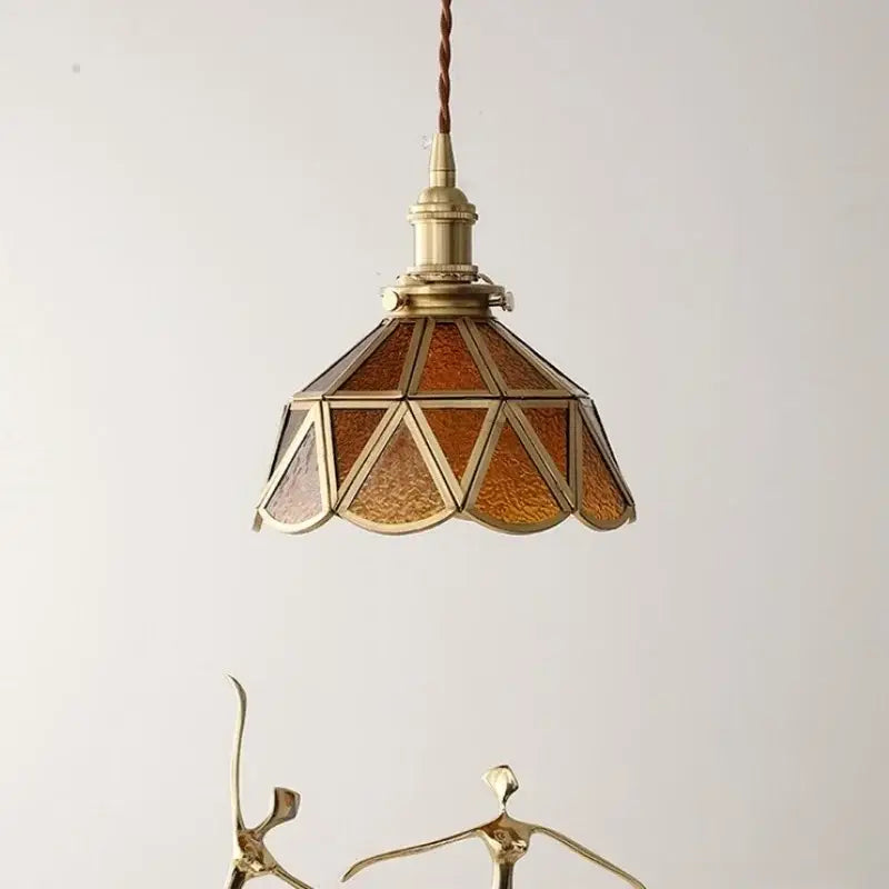 Antique brass pendant light with amber glass led panels and braided cord in a nordic modern copper suspension design