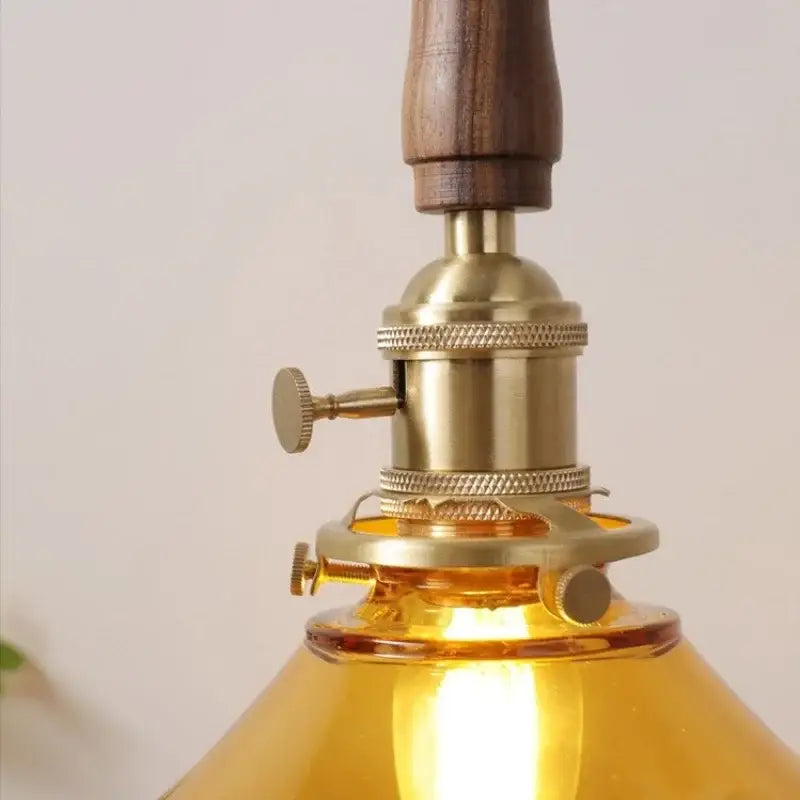 DecorBites amber glass LED pendant light with warm amber glass, brass fixture, and walnut handle for dining and living room
