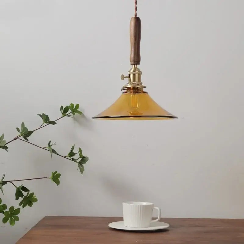 DecorBites amber glass LED pendant light with warm amber glass shade, walnut handle, and brass hardware for dining room