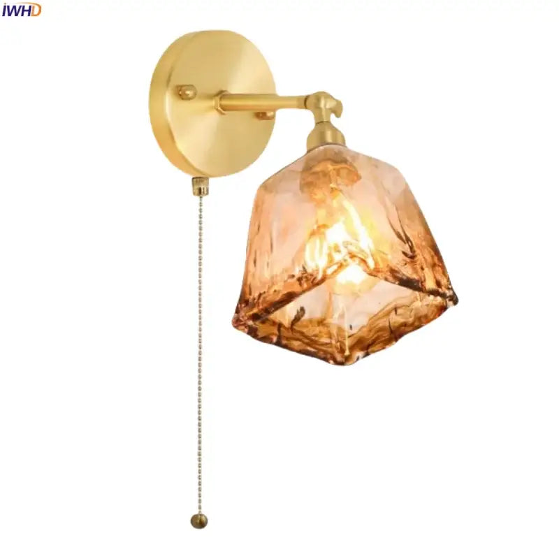 Gold-toned decorbites™ amber glass led wall lamp with faceted shade and pull-chain switch for bedroom lighting
