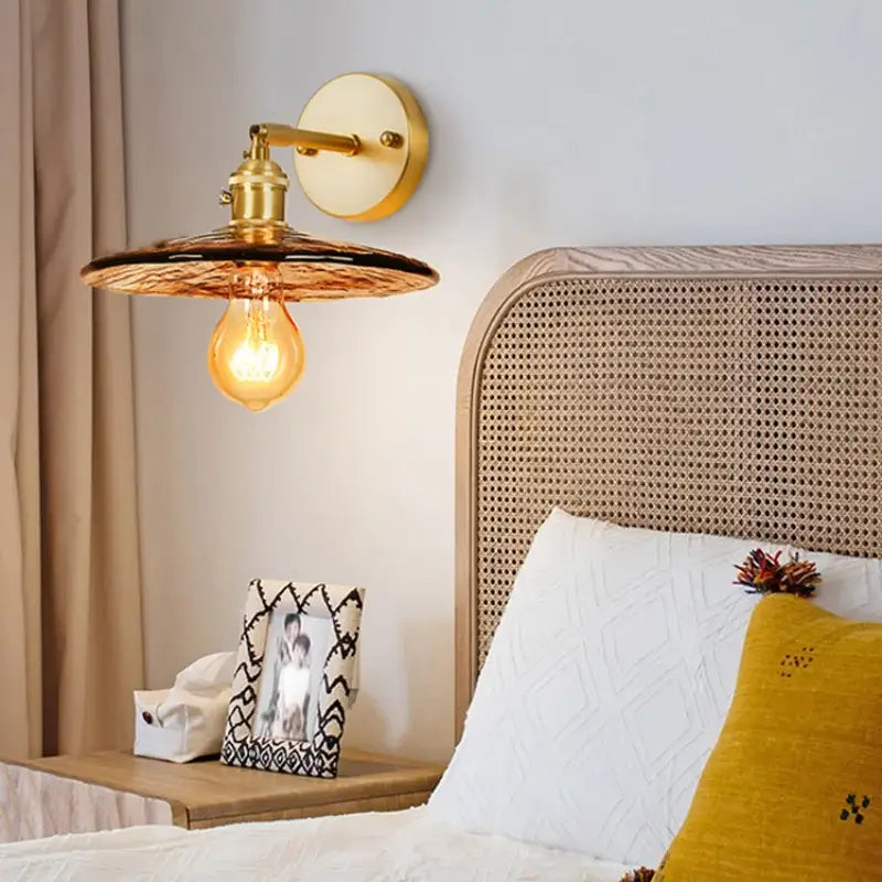 Gold-toned DecorBites amber glass led wall lamp with textured shade and exposed filament bulb for bedroom lighting