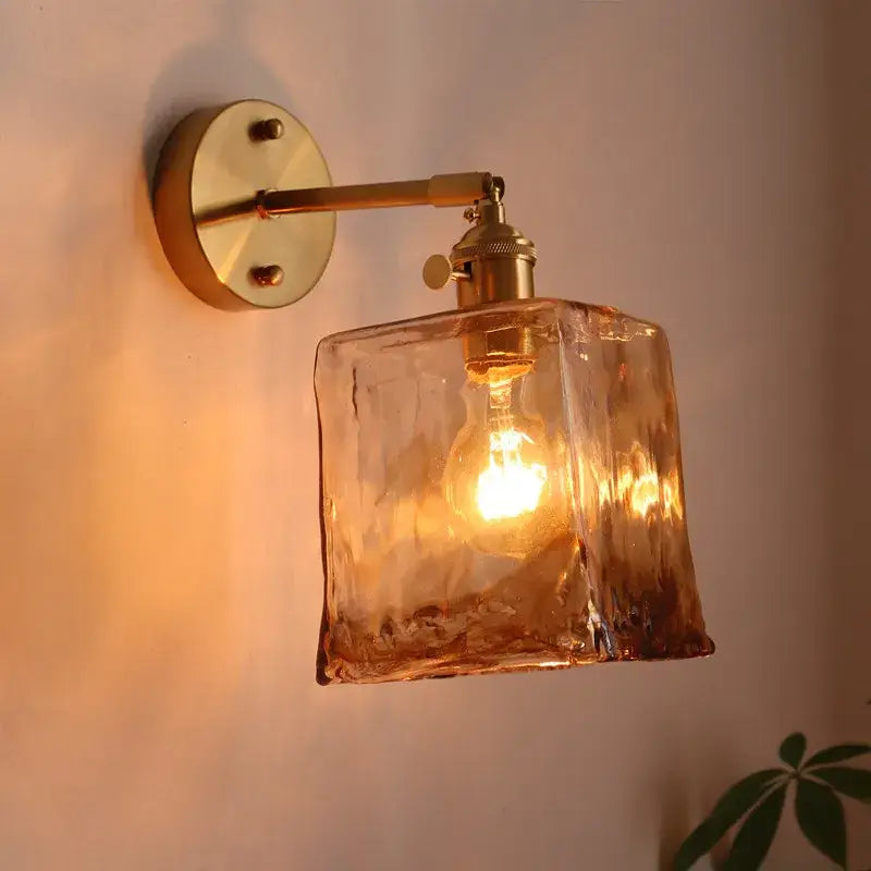 Warm amber-colored textured glass decorbites amber glass led wall lamps with brass-finished arm for living room lighting