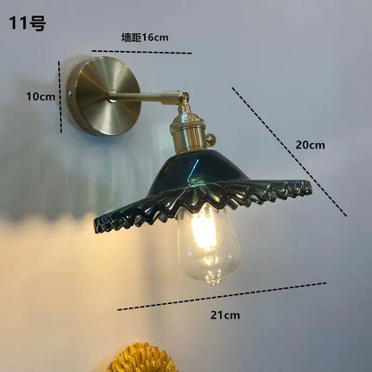 DecorBites™ amber glass wall light fixture with brass arm and dark green ceramic shade featuring on/off switch