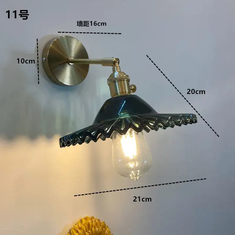 DecorBites™ amber glass wall light fixture with brass arm and dark green ceramic shade featuring on/off switch
