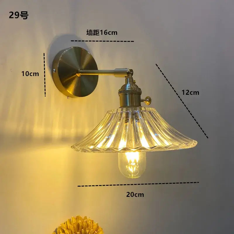 Vintage-style brass wall light fixture with fluted clear glass shade and exposed bulb by DecorBites amber glass LED