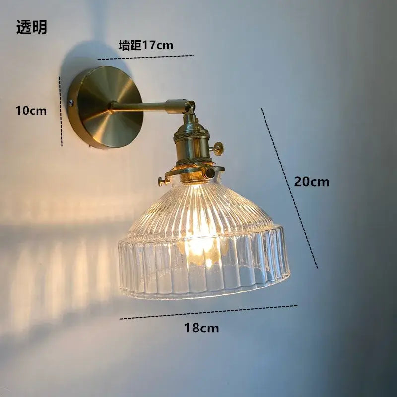 Brass-finished wall light fixture with clear ribbed amber glass shade and on/off switch Nordic modern design