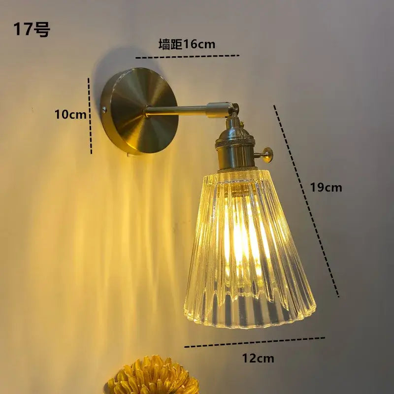 DecorBites amber glass LED wall light fixture with brass metal arm and fluted clear glass shade for warm lighting