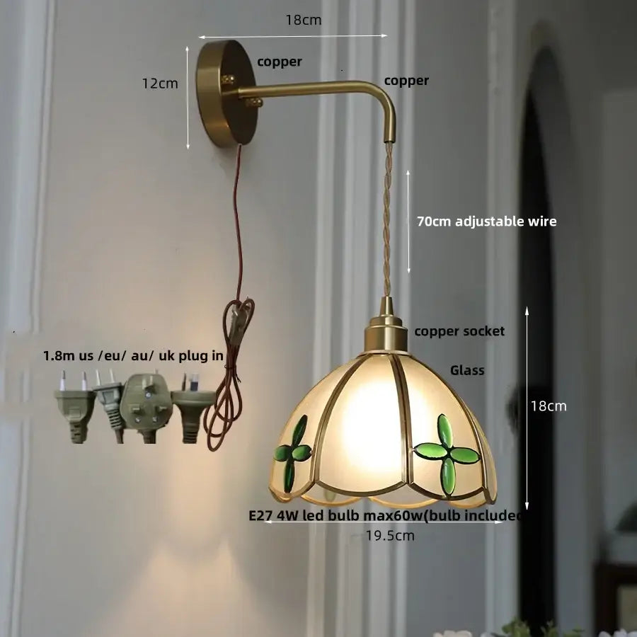 Antique brass-finished led wall light with stained glass green clover shade and adjustable copper wire for bedroom use