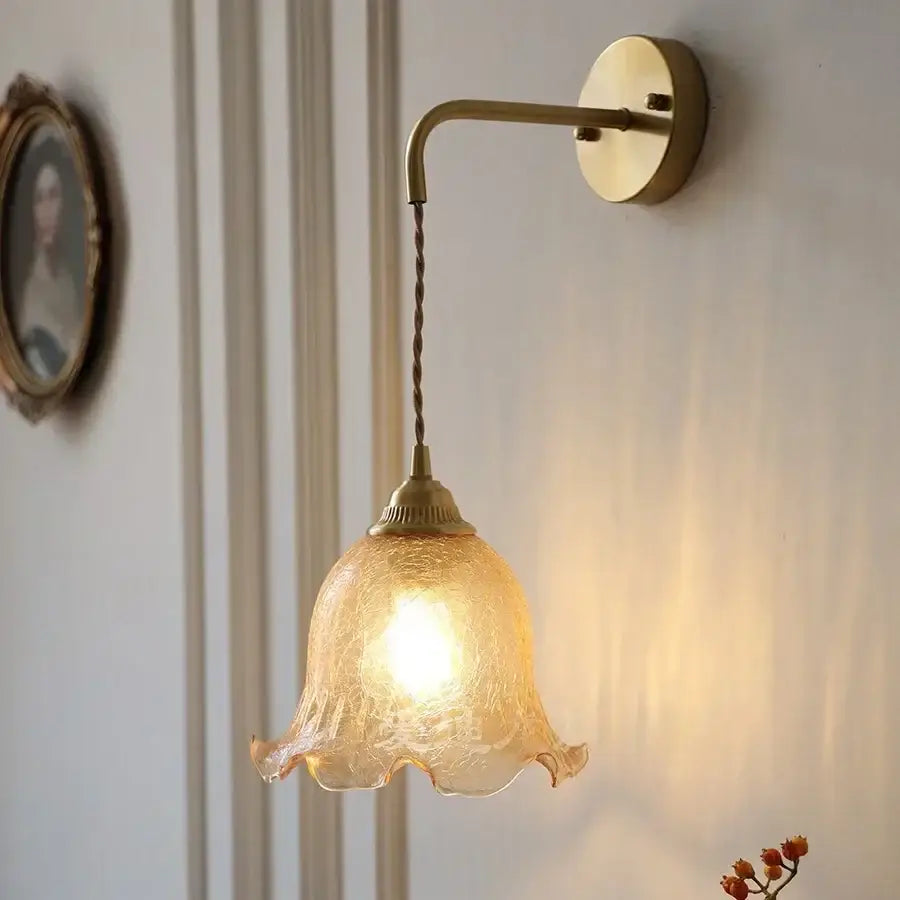 A decorbites amber glass led wall light with warm-toned textured glass shade and twisted brass chain sconce mount