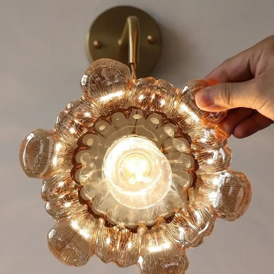 DecorBites amber glass led wall sconce with brass finish and intricate floral etched design in amber tinted glass
