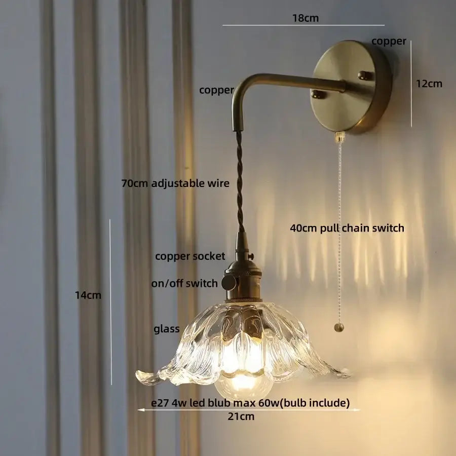 Antique brass-finished decorbites amber glass led wall sconce with petal-shaped shade and adjustable copper wire arm