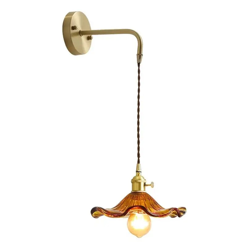 Antique brass wall sconce with twisted cord and amber glass shade from DecorBites amber glass wall lamp collection