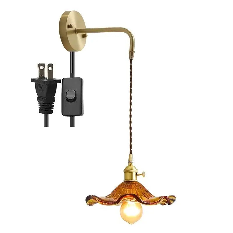 Vintage-style decorbites amber glass wall sconce with brass fixture and twisted brown cord for indoor lighting
