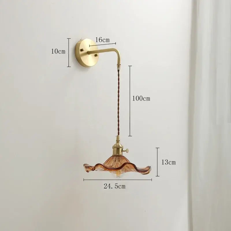 Vintage-style decorbites amber glass wall sconce with brass-finished arm and amber ruffled glass shade for indoor lighting