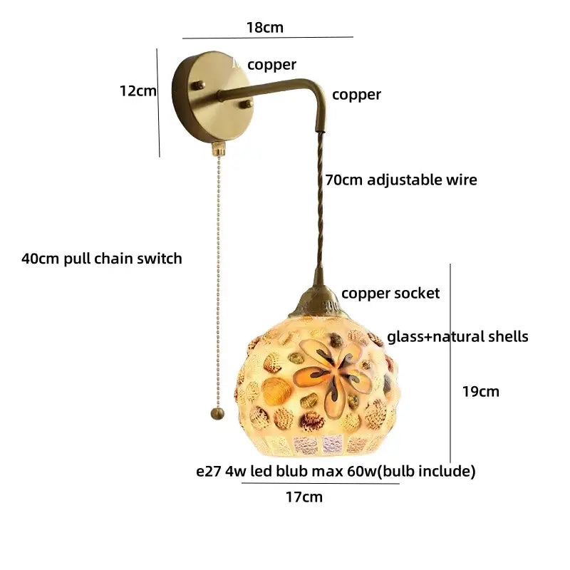A decorbites amber glass led wall sconce with brass arm and ornate shell-adorned glass globe for bedroom and bathroom