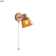 DecorBites amber glass led wall sconce with warm amber glass, wooden base, and brass pull chain for Nordic modern decor