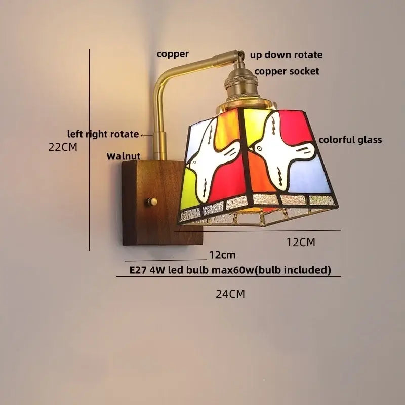 Vintage-style wall sconce with copper arm and colorful stained glass shade featuring birds for living room decor