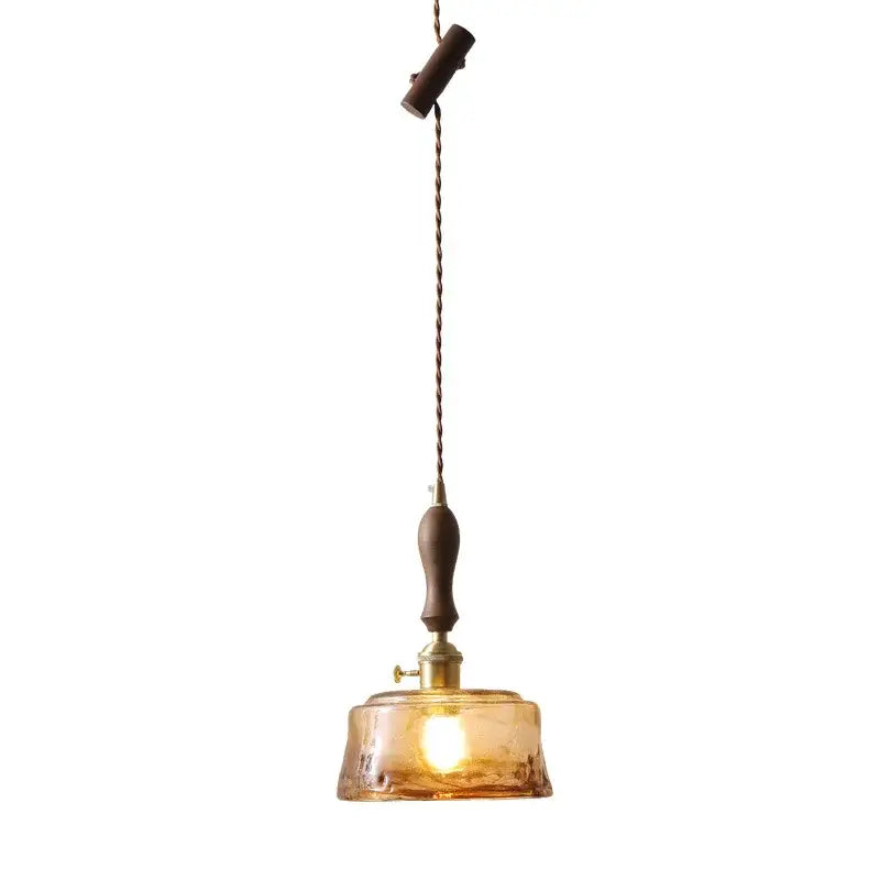 Decorbites amber glass pendant lamps featuring warm amber glass with brass fixture and dark wood accents for modern decor