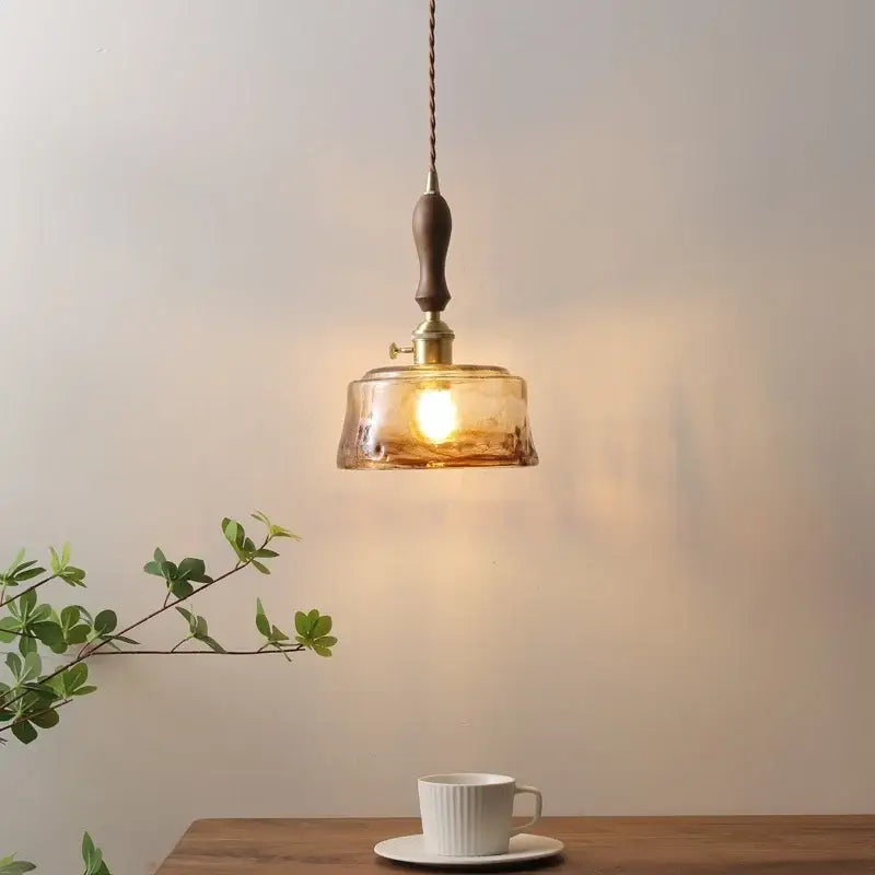 Decorbites amber glass pendant lamp with warm amber glass, wooden handle, and brass hardware for modern interiors