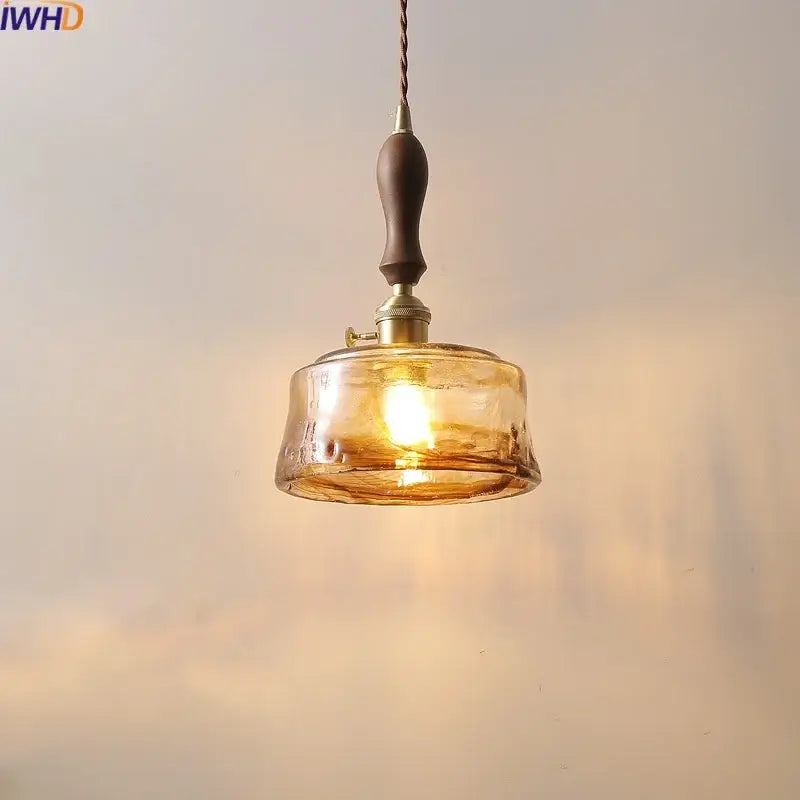 Decorbites amber glass pendant lamps with warm amber glass, dark wood handle, and brass accents for living spaces