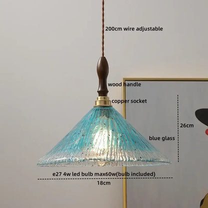A decorbites amber glass pendant lamp featuring a delicate blue textured glass shade with a dark wood handle