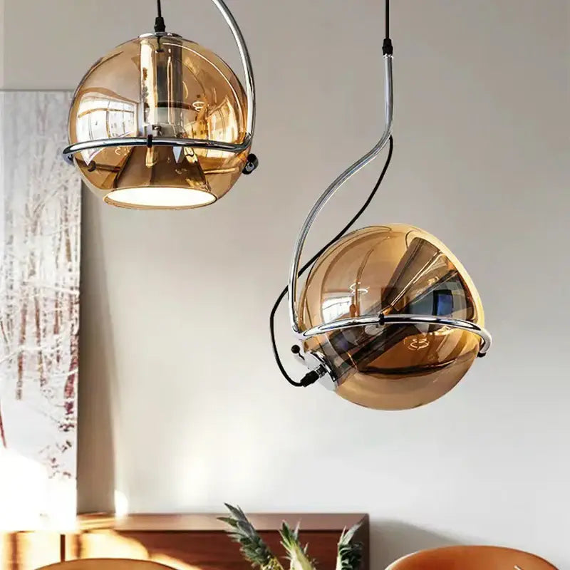 Two hanging decorbites amber glass pendant lights with chrome frames for kitchen bedroom or hallway lighting