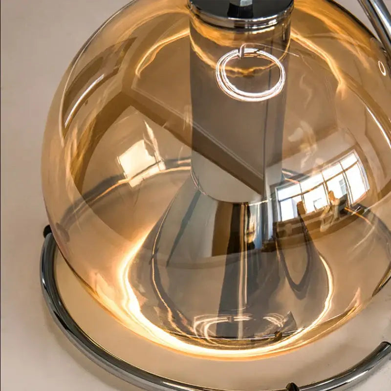 A decorbites amber glass pendant light with amber tinted glass dome and polished chrome base for versatile indoor use