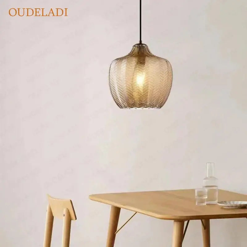 A warm-toned amber glass pendant light with a textured woven pattern from decorbites amber glass pendant lights collection