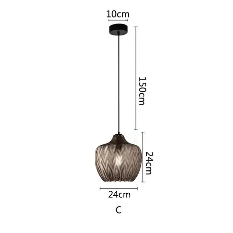 A modern decorbites amber glass pendant light with textured dark bronze shade and black metal hardware for versatile use
