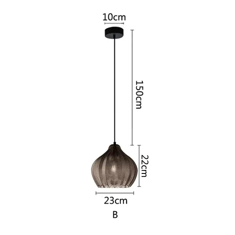 A modern black decorbites amber glass pendant light with woven textured glass shade and sleek metal chain for kitchens