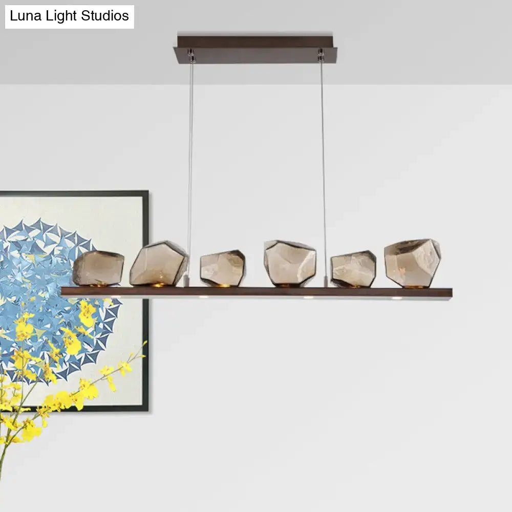 DecorBites™ amber glass stone pendant lamp with six faceted orbs on dark wood bar for 220v-240v and 110v-120v use
