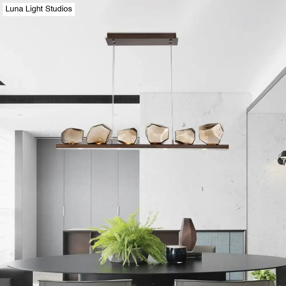 Modern geometric DecorBites amber glass stone pendant lamp with five faceted amber glass shades on dark wood bar 220v-240v 110v-120v