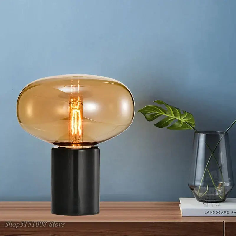 Decorbites amber glass table lamp with warm amber glass shade and sleek black cylindrical base for modern living spaces
