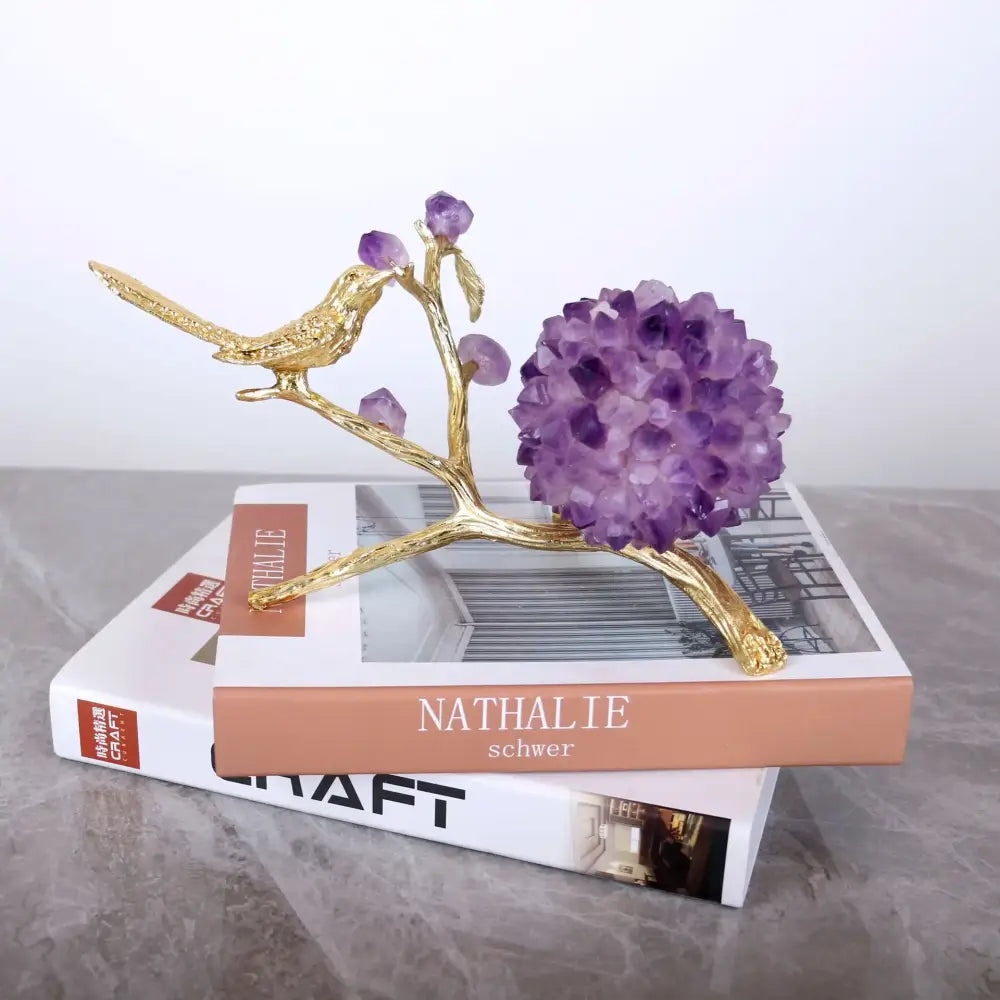 Golden ball bird sculpture perched on branch with purple amethyst flower ball crystals for elegant desk decoration