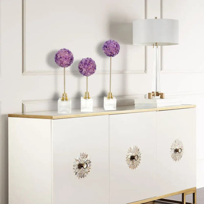 Decorbites amethyst flower metal sculpture features three elegant purple hydrangea pom-poms on gold stems in white marble bases