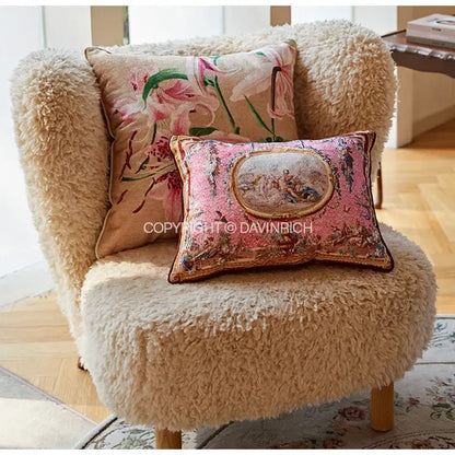 Cream-colored sheepskin armchair with two decorative cushion covers featuring ancient art vintage baroque designs