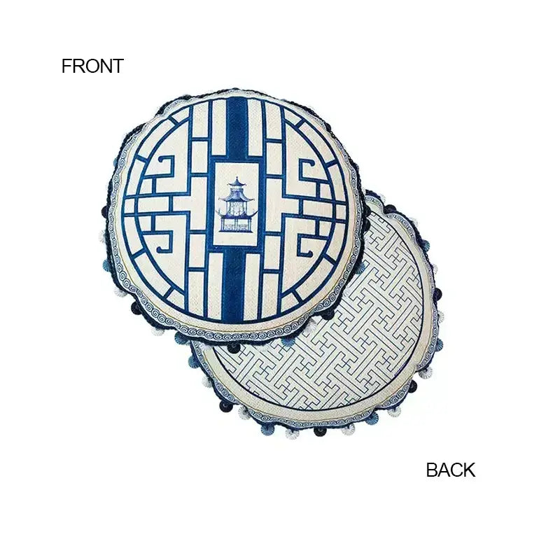 Circular hand-painted DecorBites™ cushion cover with ancient indigo jungle lattice design and black pom-pom edging