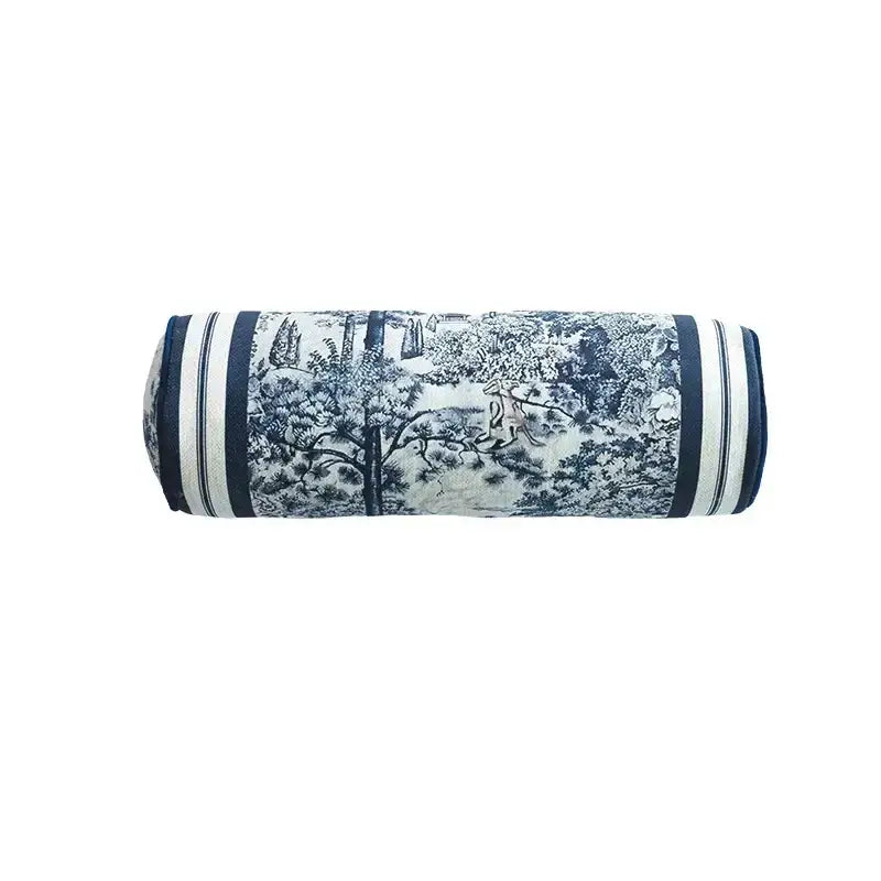 A navy and white striped cylindrical indigo jungle decorative cushion cover with a hand-painted pastoral scene