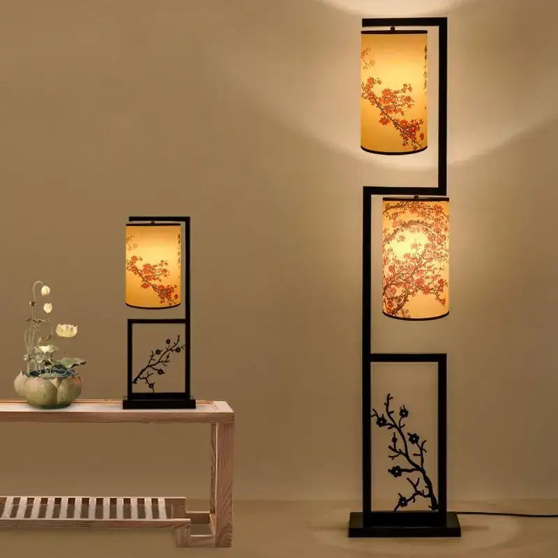 Black-framed floor lamp and table lamp with warm amber shades featuring ancient plum chinese style cherry blossom design