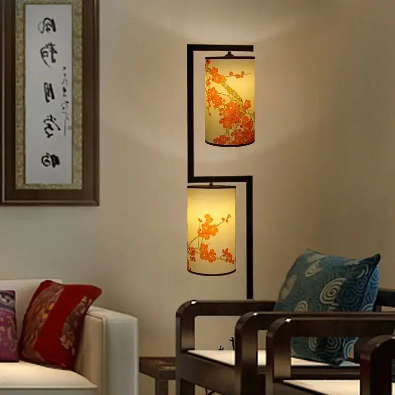 A warm-lit two-tiered cream floor lamp with orange ancient plum blossom prints in chinese style by decorbites