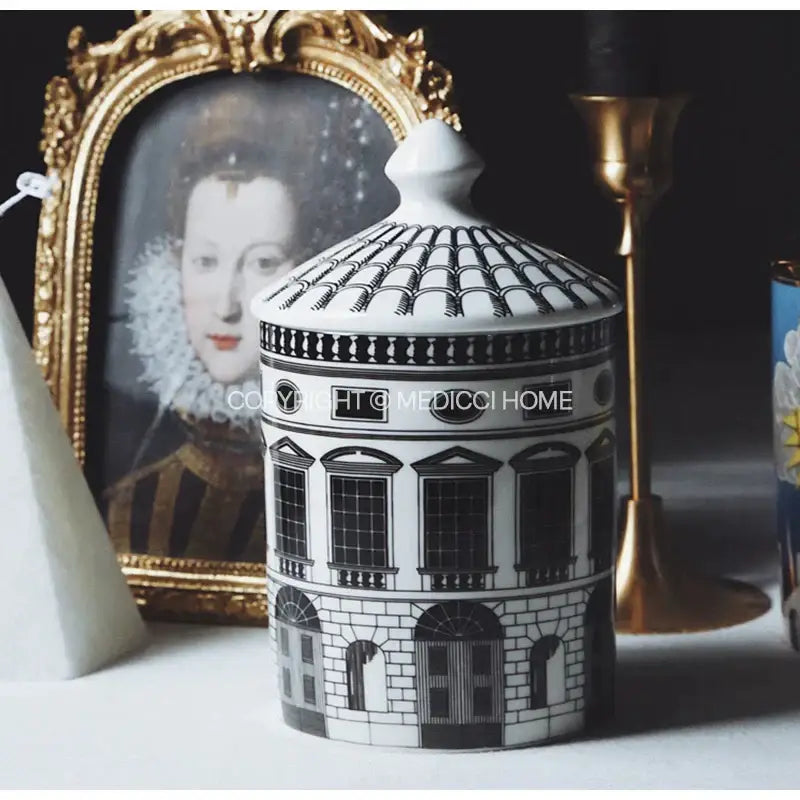 White ceramic candle jar with black decorative molding and domed lid featuring ancient roman architecture design