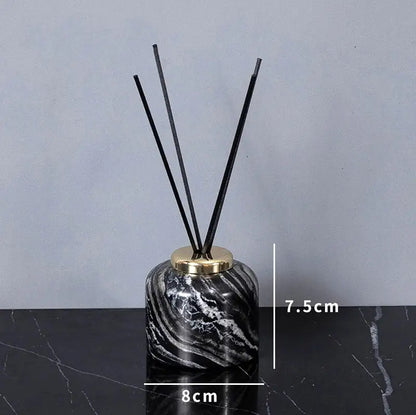 Black and white marble-patterned reed diffuser with gold-toned cap from DecorBites ancient wood grain bathroom set