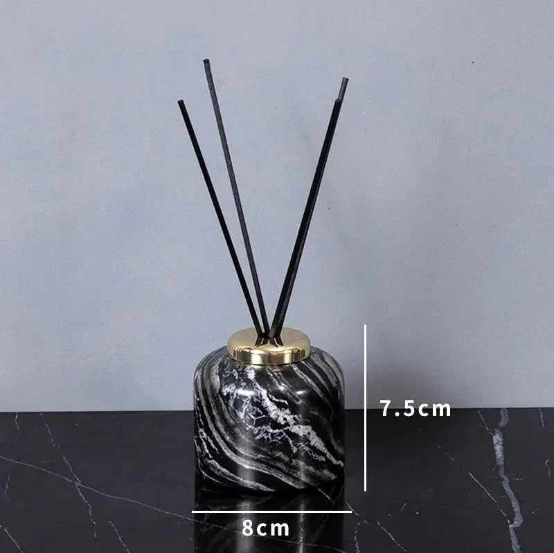 Black and white marble-patterned reed diffuser with gold-toned cap from DecorBites ancient wood grain bathroom set