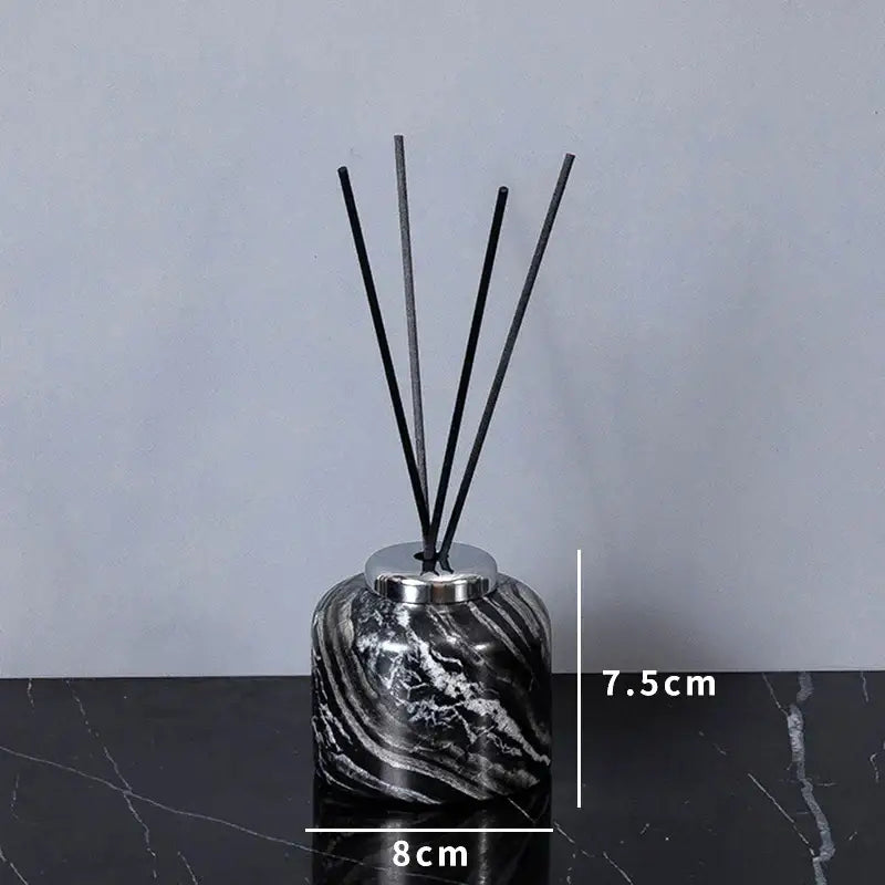 Black and white marble-patterned reed diffuser with silver cap from decorbites ancient wood grain bathroom set