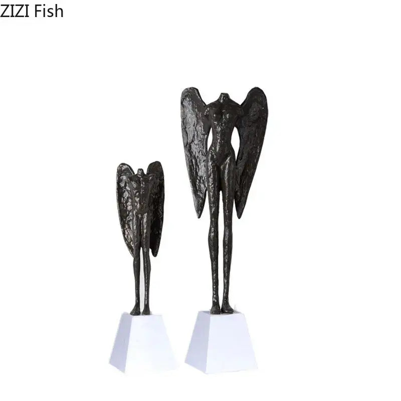Two dark textured cast iron angel abstract figures sculpture with outstretched wings on white square bases for home decor