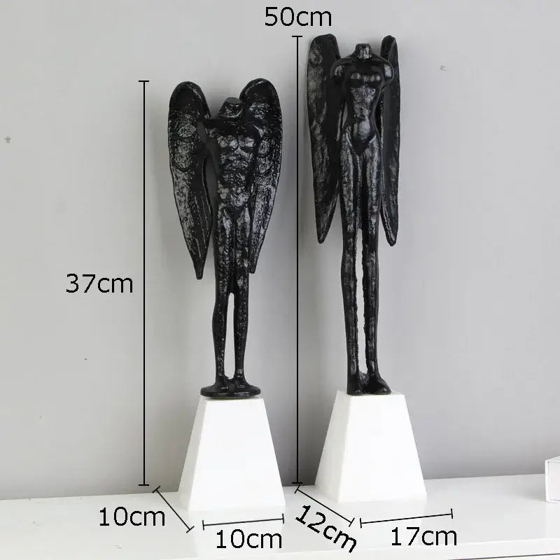 DecorBites™ black cast iron angel abstract figures sculpture with detailed wings and muscular forms on white pedestals