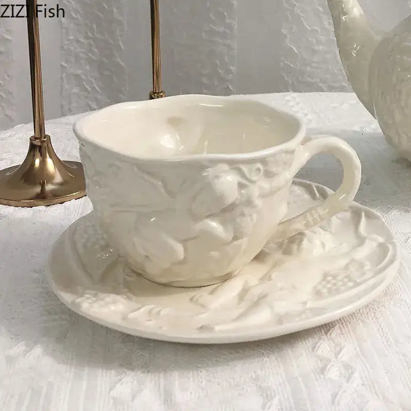 White ceramic teacup with intricate angel figures relief detailing on a matching saucer from decorbites ceramic dining set