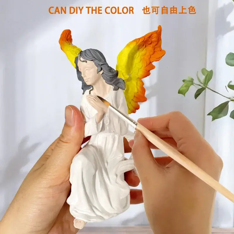 A DecorBites™ white gold resin angel figurine with gray hair and vibrant painted wings collectible statue for home decor